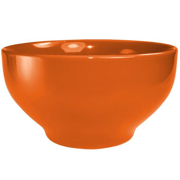 An orange International Tableware stoneware bowl.