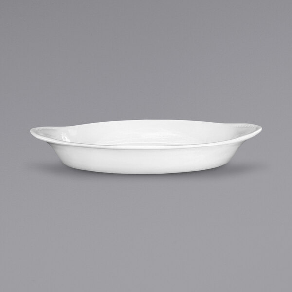 An International Tableware European White Stoneware Rarebit dish with an oval shape and a handle.