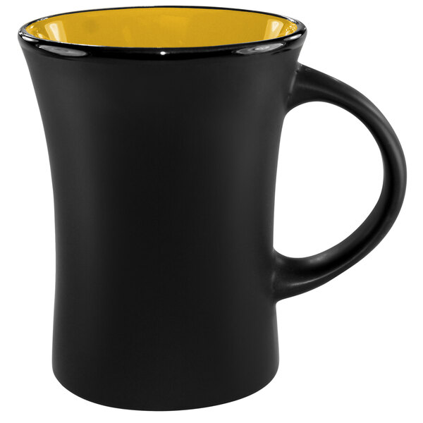 A yellow stoneware mug with a black interior and handle.