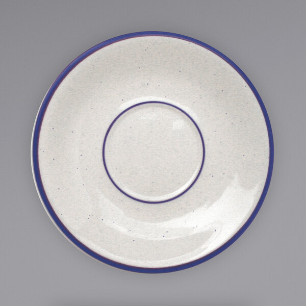An International Tableware Danube ivory saucer with blue bands and speckles.