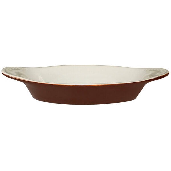 An oval brown and ivory stoneware rarebit dish with black lines.