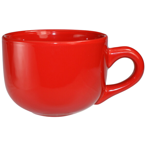 A close-up of a International Tableware crimson red stoneware latte cup with a handle.