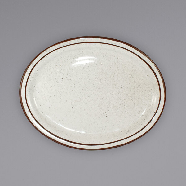 An International Tableware ivory stoneware platter with brown speckled edges and a narrow brown rim.