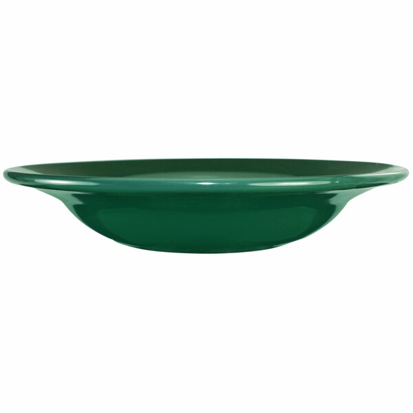 A close-up of a green International Tableware stoneware bowl with a deep rim.