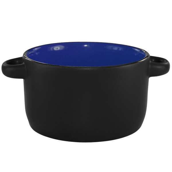 A black and country blue stoneware mini casserole dish with a handle.
