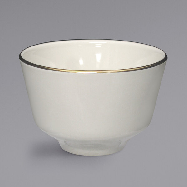 A white bowl with gold rim.