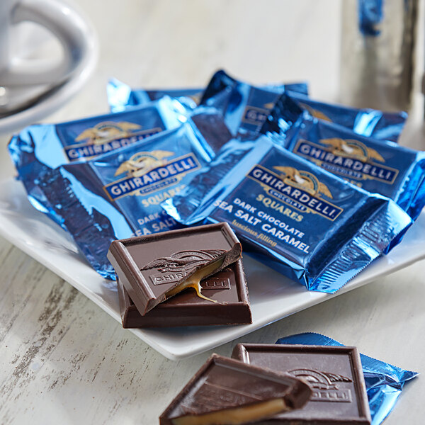 A plate of Ghirardelli dark chocolate and salted caramel candies.