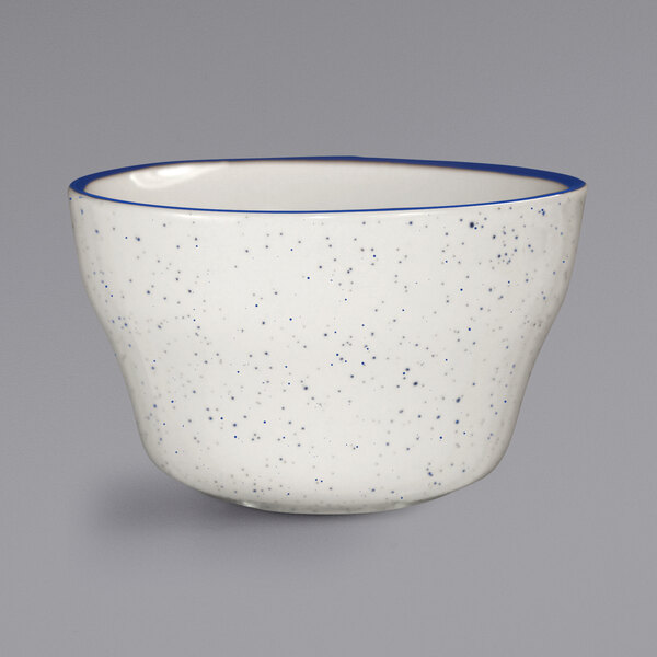 An International Tableware Danube ivory stoneware bowl with blue specks.