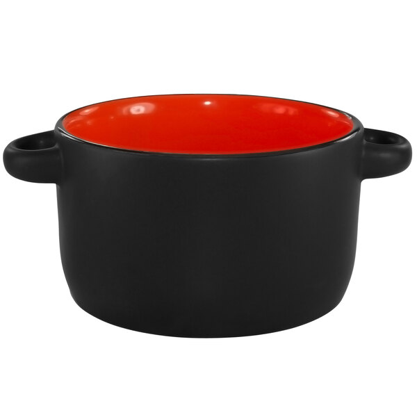 A red and black stoneware pot with handles.