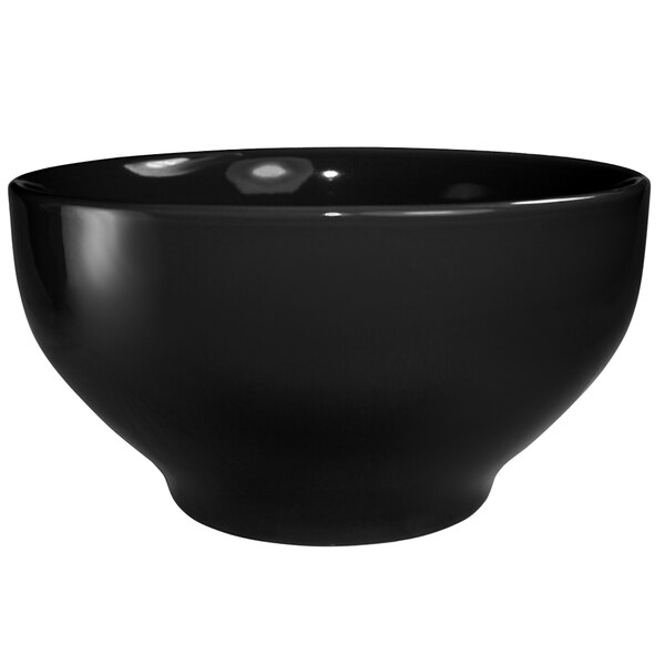 An International Tableware black stoneware footed bowl with white background.