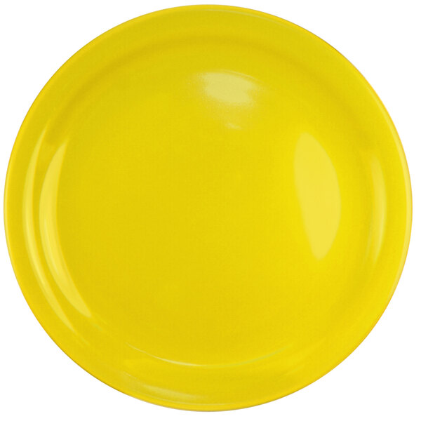 A yellow stoneware plate with a white narrow rim.