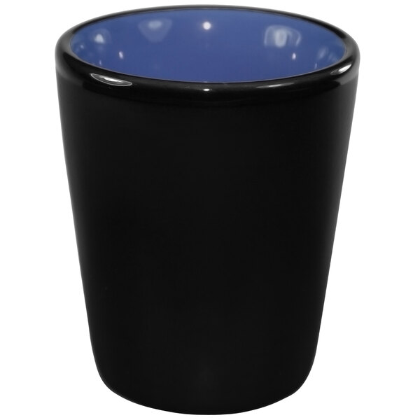 A black and country blue stoneware shot glass with a lid.