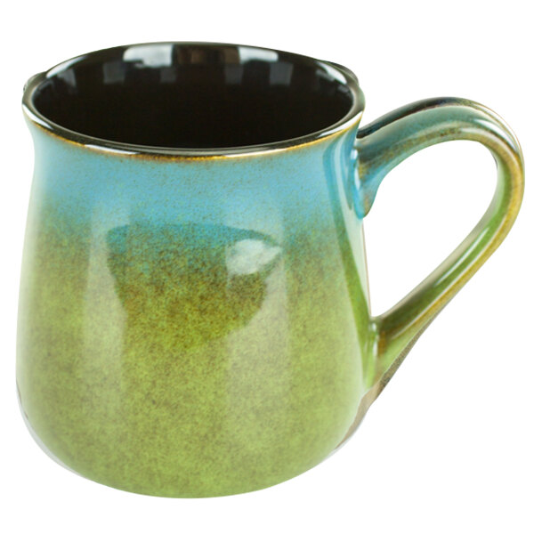 A close-up of a blue and green International Tableware Sioux Falls stoneware tavern mug with a handle.