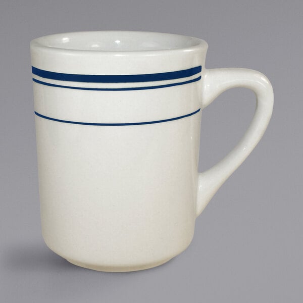 An International Tableware Catania stoneware mug with blue stripes on it.