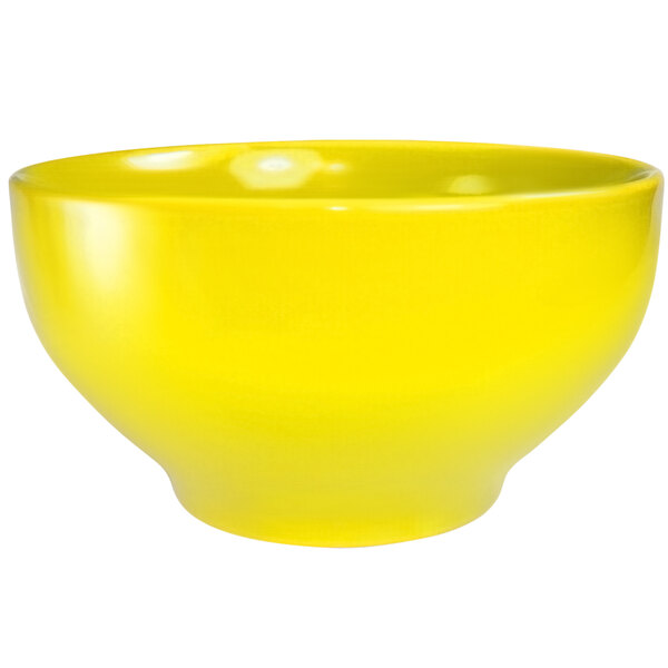 A yellow International Tableware stoneware bowl with a white background.