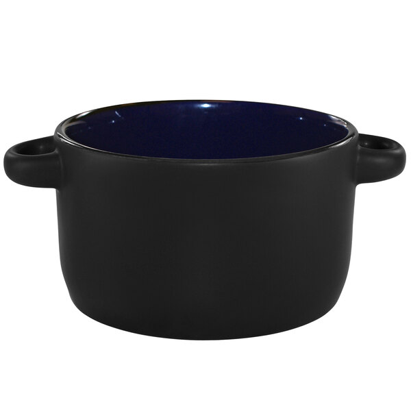 A black stoneware casserole dish with a blue rim and handles.