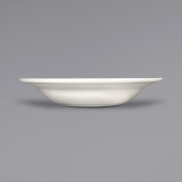 A close up of a International Tableware Roma stoneware bowl with a rolled edge.
