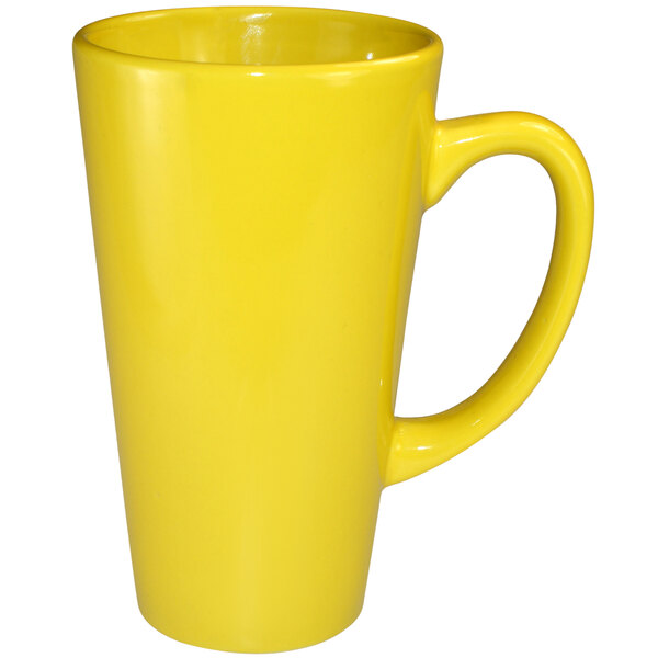 A yellow stoneware cup with a yellow handle.