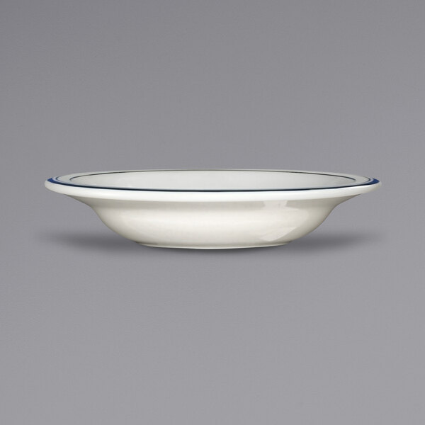 An ivory stoneware bowl with a deep rim and blue bands.