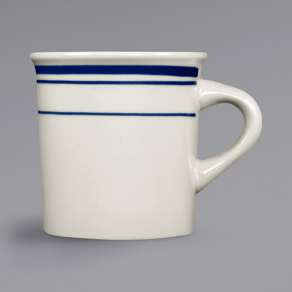An ivory stoneware Canton mug with blue stripes on the rim and handle.