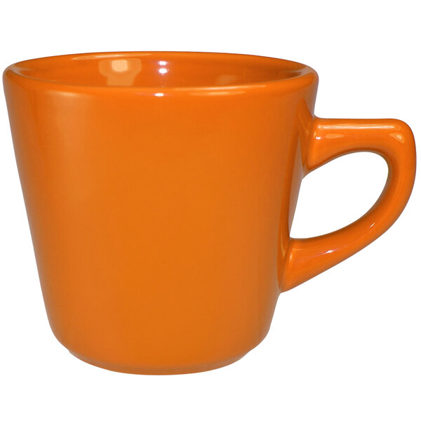 An International Tableware orange stoneware tall cup with a handle.