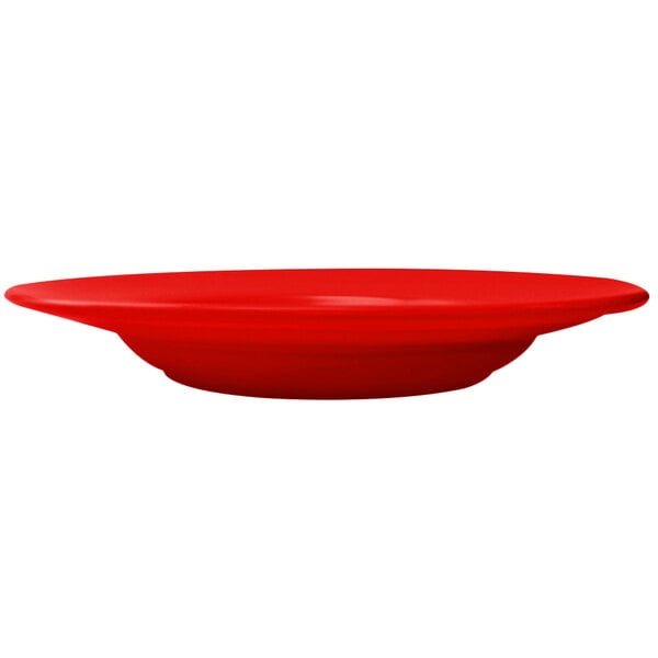 A crimson red stoneware pasta bowl on a white background.