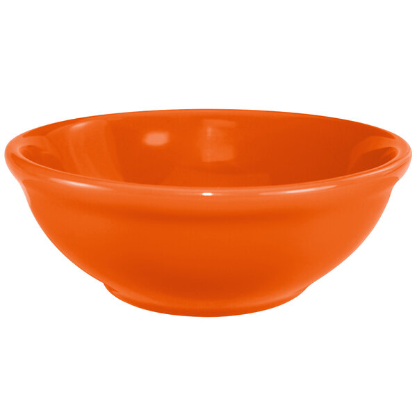 An orange International Tableware stoneware bowl.