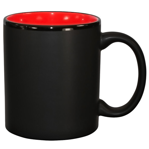 A black stoneware mug with a red rim and interior.