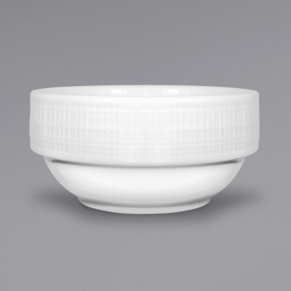 A close up of an International Tableware Dresden fruit bowl with a white surface and rim.