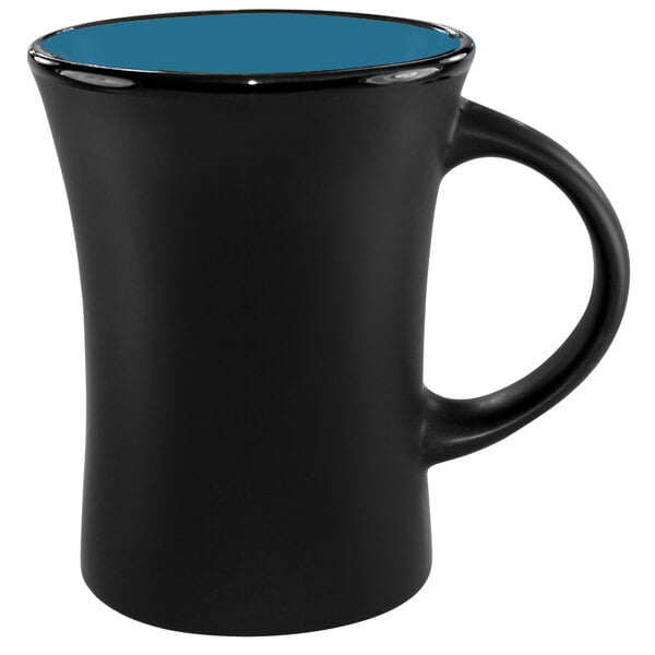 A black stoneware mug with a blue rim.