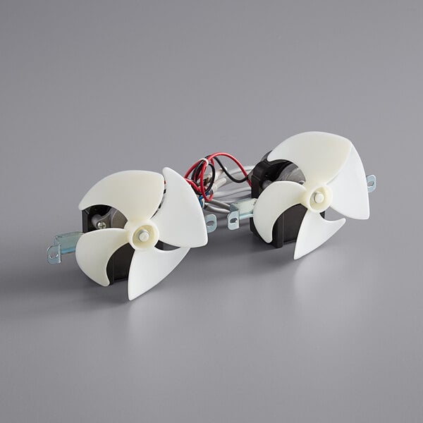 A white plastic Avantco fan propeller with wires.