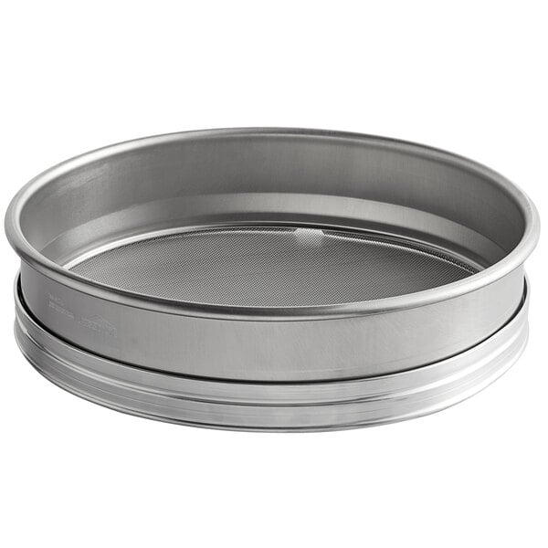 A silver Vollrath stainless steel sieve with a mesh inside.