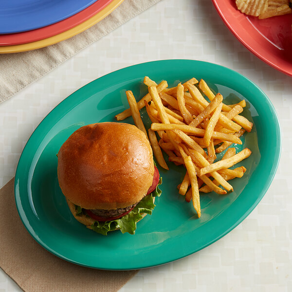 An oval melamine platter with a hamburger and fries on it.