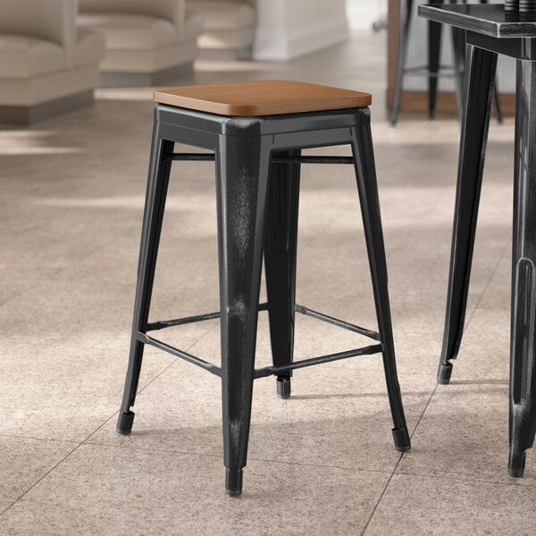 Lancaster Table & Seating Alloy Series Distressed Black Indoor Backless Counter Height Stool with Walnut Wood Seat
