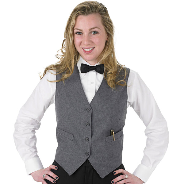 A woman wearing a Henry Segal customizable gray server vest and bow tie.