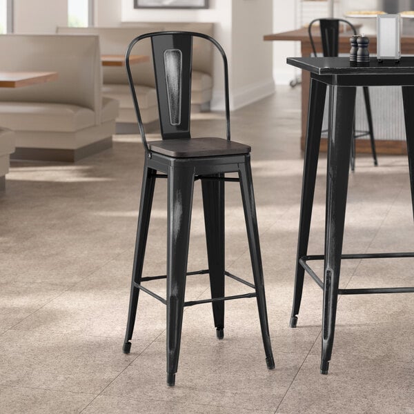 Lancaster Table & Seating Alloy Series Distressed Black Indoor Cafe Barstool with Black Wood Seat