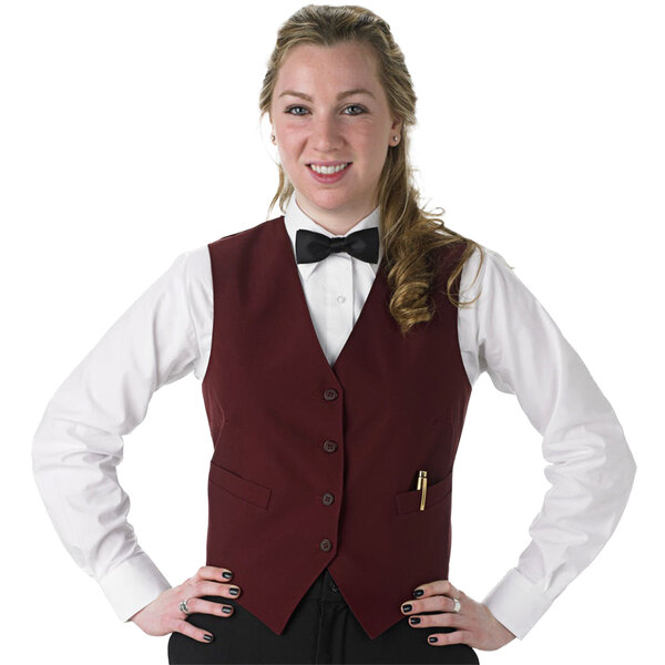 A woman in a burgundy Henry Segal server vest and bow tie.
