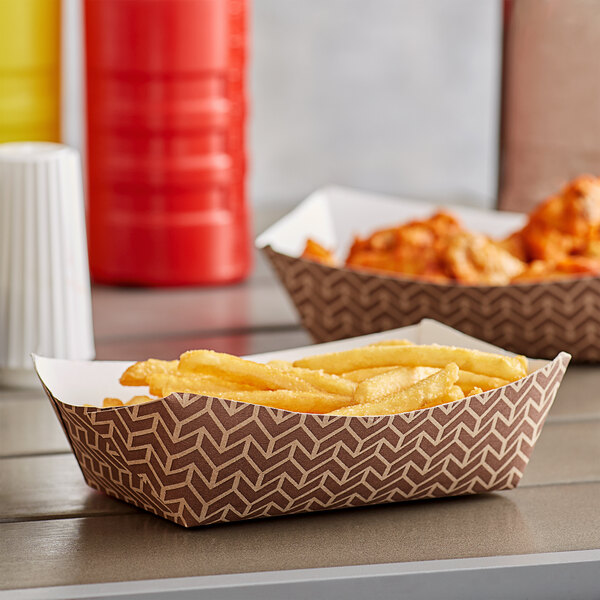 A table with a white Carnival King paper food tray filled with fries and chicken wings.