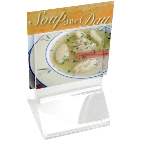 A clear acrylic Cal-Mil displayette with a sign on it.