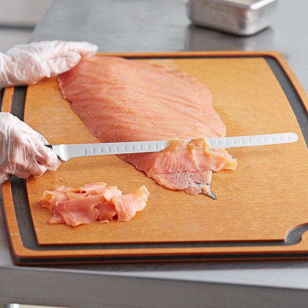 A Wusthof Classic forged knife slicing salmon.