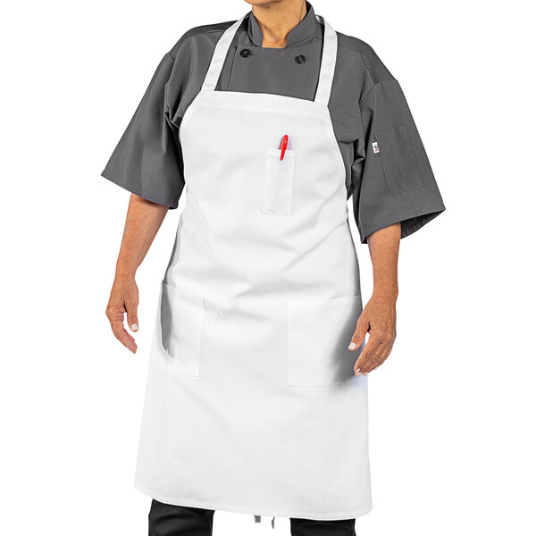 A man wearing a white Uncommon Chef bib apron.