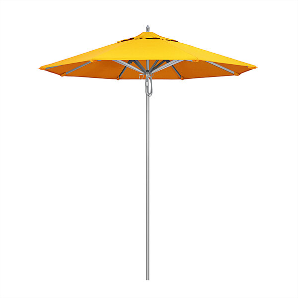 A California Umbrella with a Sunbrella sunflower yellow canopy on a metal pole.