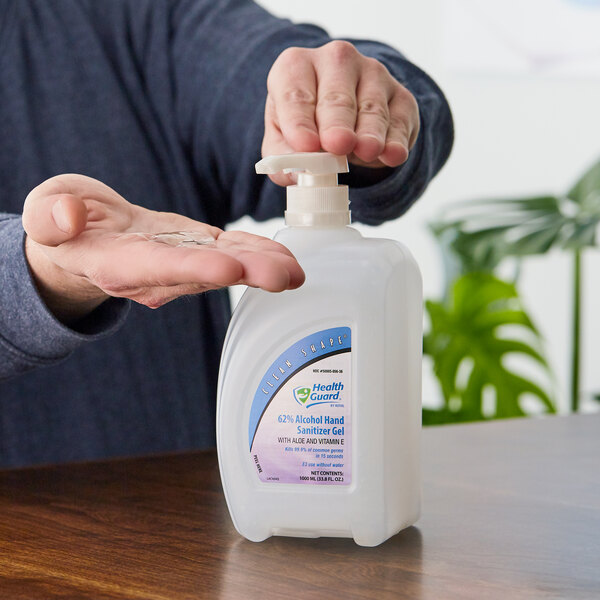 A person's hand using a Kutol Clean Shape pump bottle of alcohol hand sanitizer gel.