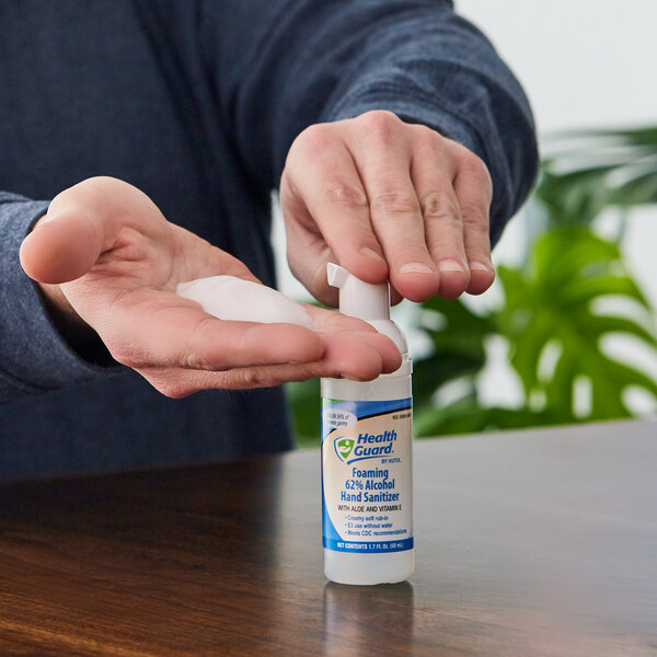 A person using a Kutol Health Guard alcohol hand sanitizer.