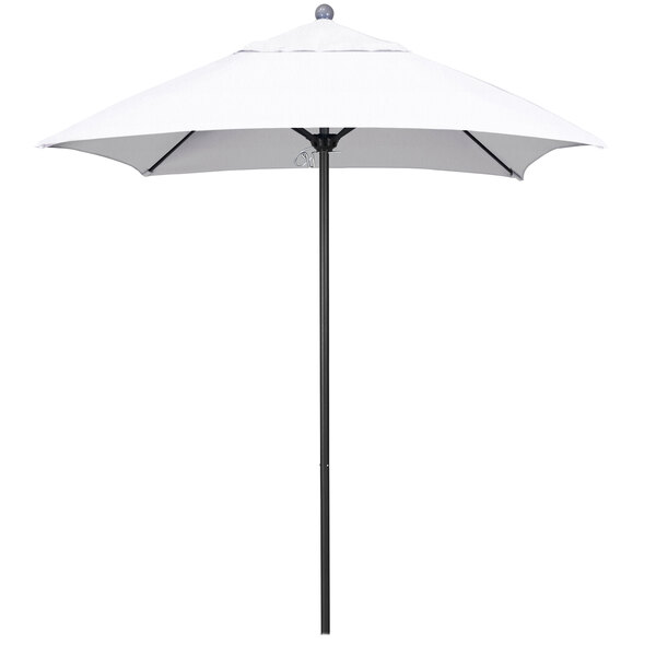 A white California Umbrella on a silver pole.
