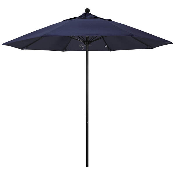 A California Umbrella ALTO round outdoor umbrella with a navy blue Sunbrella canopy.