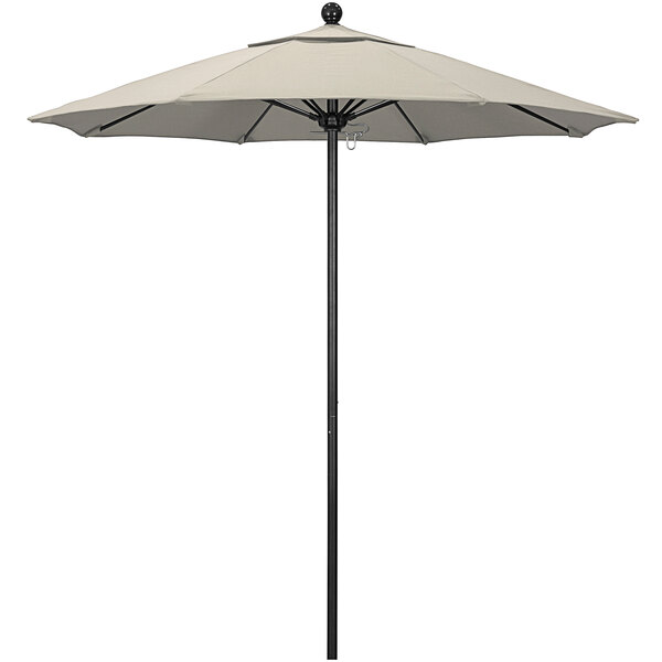 A beige California Umbrella with a black pole.