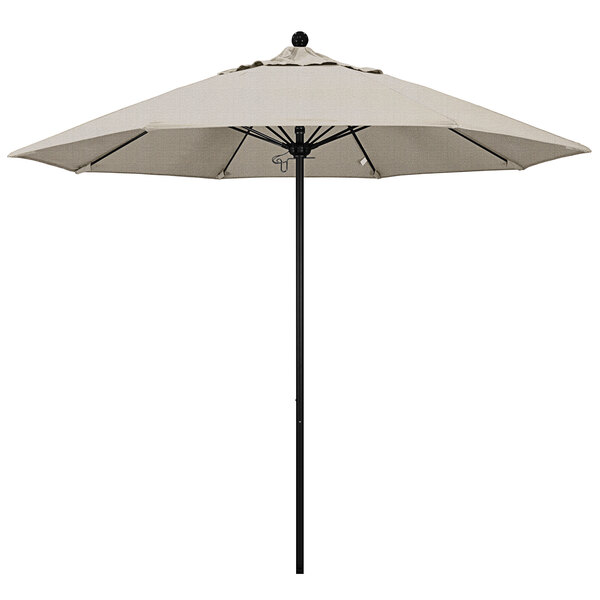 A white California Umbrella on a black pole.