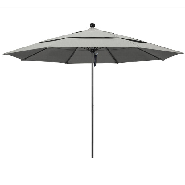 A grey California Umbrella ALTO Sunbrella round umbrella with a black pole.