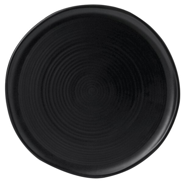 A close-up of a black Dudson Evo stoneware plate with a spiral pattern.